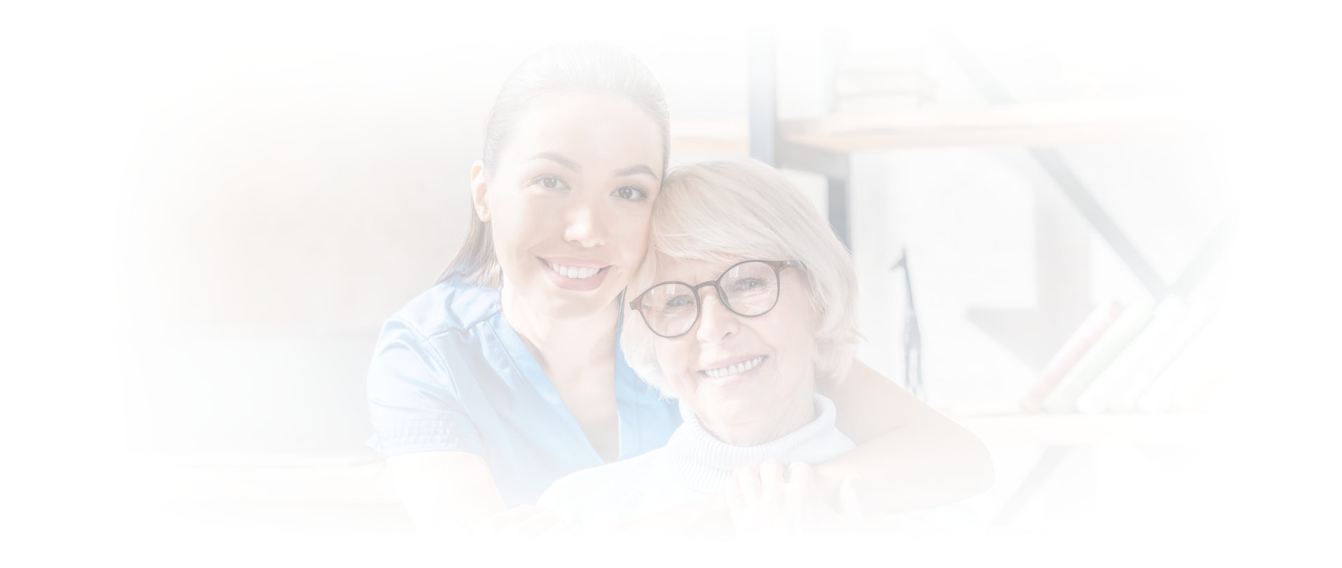 caregiver hugging senior woman from the back
